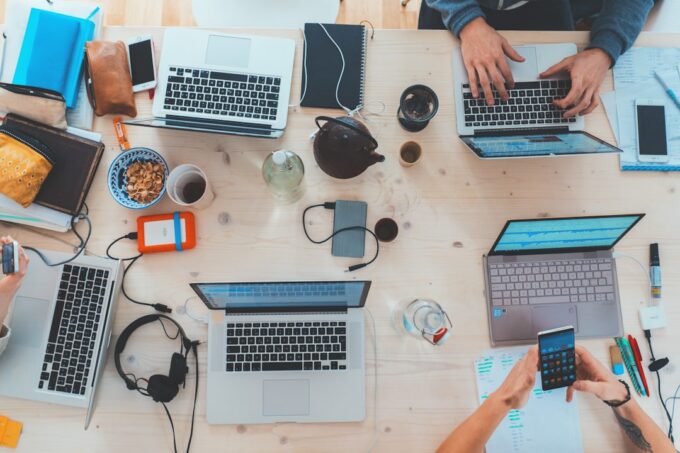 Professional guiding a colleague through digital business tools