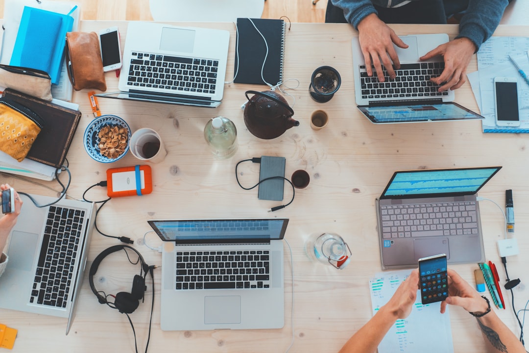 Professional guiding a colleague through digital business tools
