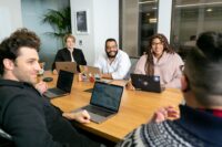 Office team meeting with a remote colleague by video call