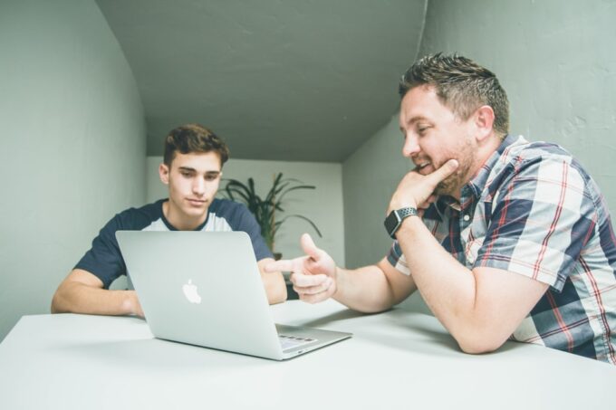 Experienced professional mentoring a younger colleague