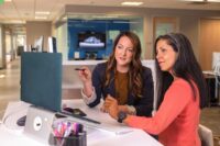 Women leaders collaborating in a modern office meeting